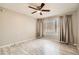 Bedroom offers natural light through a window with blinds and curtains plus wood-look flooring at 4955 Lindell Rd # 130, Las Vegas, NV 89118