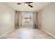 Cozy bedroom with wood-look floors, neutral walls and window dressed with blinds and curtains at 4955 Lindell Rd # 130, Las Vegas, NV 89118