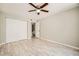 Bedroom featuring wood-look flooring, ceiling fan, and a closet with sliding doors at 4955 Lindell Rd # 130, Las Vegas, NV 89118