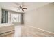 A well lit bedroom featuring neutral walls, wood-look flooring, and a window with decorative curtains at 4955 Lindell Rd # 130, Las Vegas, NV 89118