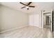 This is a cozy bedroom with wood-look flooring and a ceiling fan with a light fixture at 4955 Lindell Rd # 130, Las Vegas, NV 89118