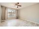 Bright bedroom with wood-look flooring, large window with gray curtains, and a ceiling fan at 4955 Lindell Rd # 130, Las Vegas, NV 89118