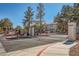 Gated community entrance with secure access, mature trees, and well-maintained landscaping in a desirable neighborhood at 4955 Lindell Rd # 130, Las Vegas, NV 89118