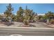 Gated community entrance with mature trees and well-manicured landscaping at 4955 Lindell Rd # 130, Las Vegas, NV 89118