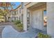 Inviting condo exterior with security door, mature trees, and a well-maintained walkway at 4955 Lindell Rd # 130, Las Vegas, NV 89118