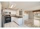 Open layout of kitchen featuring stainless steel appliances flowing into living area with balcony access at 4955 Lindell Rd # 130, Las Vegas, NV 89118