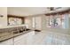 Bright living area features tile floors, ceiling fan and a breakfast bar with granite countertops into the kitchen at 4955 Lindell Rd # 130, Las Vegas, NV 89118