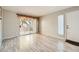 Cozy living room with wood-look floors and sliding glass doors to private balcony at 4955 Lindell Rd # 130, Las Vegas, NV 89118