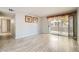 Bright living room features wood-look floors, patio access, and closet storage at 4955 Lindell Rd # 130, Las Vegas, NV 89118
