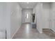 Neutral hallway featuring tile flooring, access to multiple rooms, and a bright entry door at 5234 Savannah Rose St, Las Vegas, NV 89149
