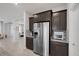 Modern kitchen with stainless steel refrigerator, granite counters, and ample cabinet space at 5234 Savannah Rose St, Las Vegas, NV 89149