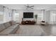Spacious living room featuring modern decor, a ceiling fan, and a large TV with stylish accent wall at 5234 Savannah Rose St, Las Vegas, NV 89149
