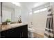 Bright bathroom featuring granite countertops, dark cabinetry, and a shower-tub combo at 5439 Bradford Pear Dr, Las Vegas, NV 89122