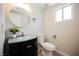 Bright bathroom featuring a stylish vanity, round mirror, and a modern toilet at 5439 Bradford Pear Dr, Las Vegas, NV 89122
