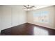 Spacious bedroom with a decorative accent wall, ceiling fan, and hardwood flooring at 5439 Bradford Pear Dr, Las Vegas, NV 89122