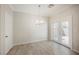 Dining area with tile floor, stylish chandelier and access to the backyard through glass panel doors at 5439 Bradford Pear Dr, Las Vegas, NV 89122