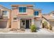 Two-story home showcasing neutral stucco facade, covered porch entry, manicured landscaping, and attached garage at 5439 Bradford Pear Dr, Las Vegas, NV 89122