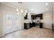 Bright eat-in kitchen features stainless appliances, dark cabinetry, and stylish chandelier lighting at 5439 Bradford Pear Dr, Las Vegas, NV 89122