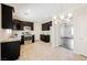 Eat-in kitchen features dark cabinetry, stainless appliances and an open layout to the living room at 5439 Bradford Pear Dr, Las Vegas, NV 89122