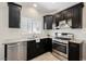 Kitchen featuring granite countertops, stainless steel appliances, and dark wood cabinets at 5439 Bradford Pear Dr, Las Vegas, NV 89122