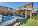 Backyard with a covered patio, in-ground spa, comfortable seating, and artificial turf at 5442 Bristol Bend Ct, Las Vegas, NV 89135
