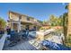 Outdoor living space with a built-in pool, patio seating, and mature landscaping at 5442 Bristol Bend Ct, Las Vegas, NV 89135