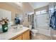 Bright bathroom featuring a tub-shower combo, large mirror, and a neutral color palette at 5442 Bristol Bend Ct, Las Vegas, NV 89135