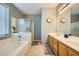 A bright bathroom boasts double sinks, a bathtub, and a separate shower for added convenience at 5442 Bristol Bend Ct, Las Vegas, NV 89135