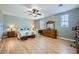Spacious bedroom with wood floors, a ceiling fan, and natural light offers a relaxing retreat at 5442 Bristol Bend Ct, Las Vegas, NV 89135