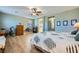 A large bedroom includes wood floors, a ceiling fan, and a view into the en-suite bathroom at 5442 Bristol Bend Ct, Las Vegas, NV 89135