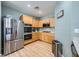Well-lit kitchen featuring light wood cabinetry, stainless steel appliances, and efficient layout at 5442 Bristol Bend Ct, Las Vegas, NV 89135