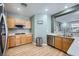 Modern kitchen featuring stainless steel appliances, light oak cabinetry, and solid surface countertops at 5442 Bristol Bend Ct, Las Vegas, NV 89135