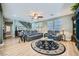 Spacious living room featuring hardwood floors, a ceiling fan, and abundant natural light at 5442 Bristol Bend Ct, Las Vegas, NV 89135