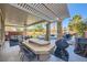 Spacious outdoor kitchen and entertainment area with a bar, seating, and built-in grill at 5442 Bristol Bend Ct, Las Vegas, NV 89135