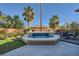 Beautiful pool with a waterfall feature surrounded by lush landscaping and comfortable seating at 5442 Bristol Bend Ct, Las Vegas, NV 89135