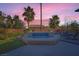 Landscaped pool with a waterfall feature surrounded by lush vegetation and comfortable lounge area at 5442 Bristol Bend Ct, Las Vegas, NV 89135