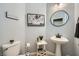 A half bathroom with a pedestal sink and a decorative picture enhances the home's functionality at 5442 Bristol Bend Ct, Las Vegas, NV 89135