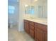 Bathroom featuring double vanity with storage and tile flooring, offering a clean design at 5513 Silent Springs Dr, Las Vegas, NV 89122