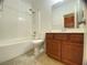 Bathroom features tub/shower combination, toilet, vanity with dark wood cabinets at 5513 Silent Springs Dr, Las Vegas, NV 89122
