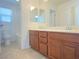 Bathroom featuring double vanity with storage and tile flooring, offering a clean design at 5513 Silent Springs Dr, Las Vegas, NV 89122