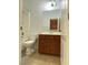 Bathroom features white toilet, vanity with dark wood cabinets at 5513 Silent Springs Dr, Las Vegas, NV 89122