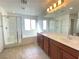 Bright bathroom with a double sink vanity, tub, and separate shower enclosure at 5513 Silent Springs Dr, Las Vegas, NV 89122
