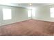 Large bedroom with multiple windows and a spacious carpeted floor, offering ample natural light at 5513 Silent Springs Dr, Las Vegas, NV 89122