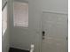 Entryway featuring white walls, dark carpet and door with windows at 5513 Silent Springs Dr, Las Vegas, NV 89122