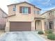 Two-story home with a two-car garage and desert landscaping at 5513 Silent Springs Dr, Las Vegas, NV 89122