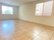 Bright, airy living room featuring tile floors and large windows at 5513 Silent Springs Dr, Las Vegas, NV 89122