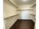 Walk-in closet with carpet flooring, shelves, and hanging rods at 5513 Silent Springs Dr, Las Vegas, NV 89122