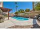 Sparkling pool with lounge area, BBQ grill, and lush landscaping for outdoor enjoyment at 5517 Bowerman Way, Las Vegas, NV 89130