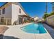 Beautiful pool area with a covered patio, barbecue, and well-maintained landscaping at 5517 Bowerman Way, Las Vegas, NV 89130