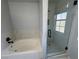 Modern bathroom with tub and updated walk-in shower featuring tile surround at 5517 Bowerman Way, Las Vegas, NV 89130